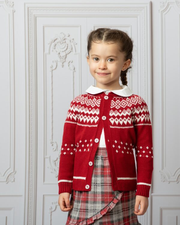 girls christmas outfit on model by wall