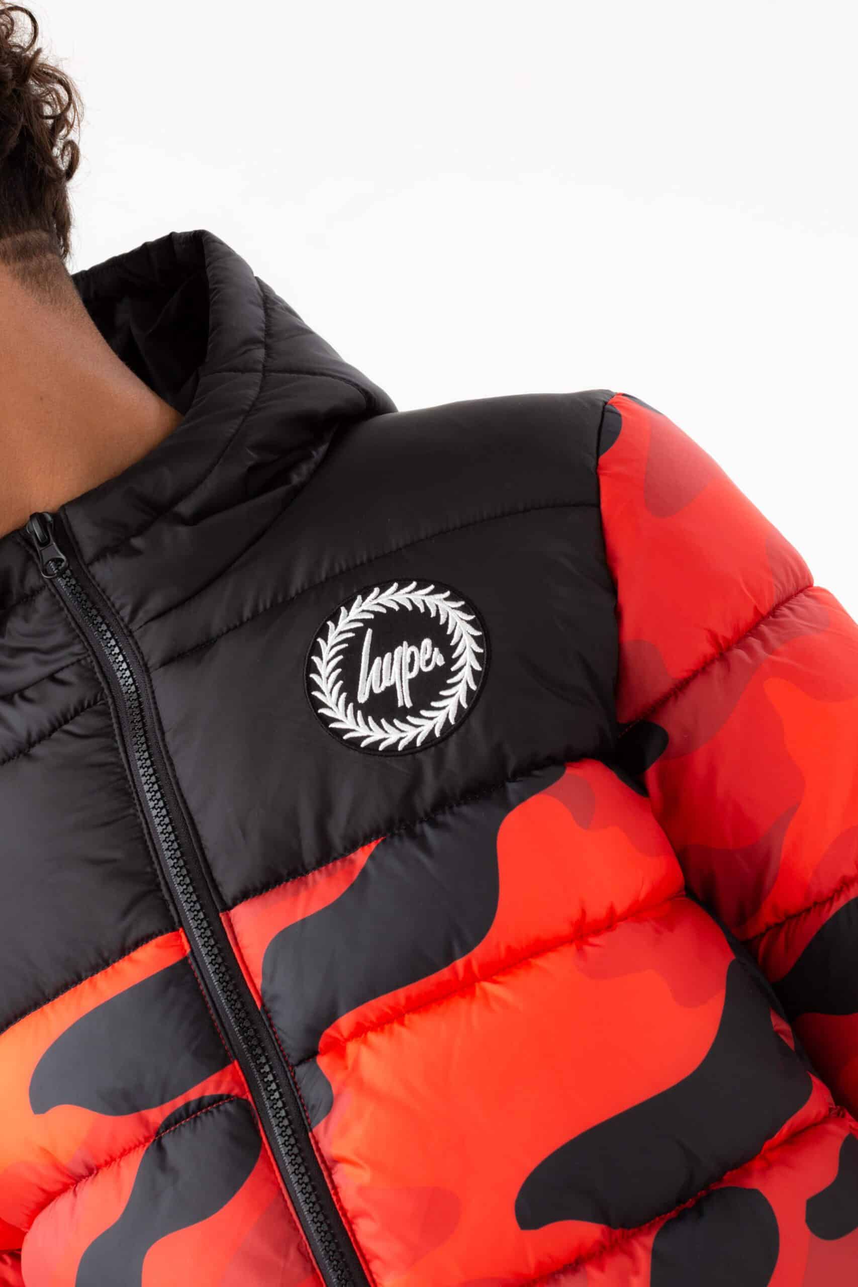 hype boys orange and black camo puffer jacket close up of logo