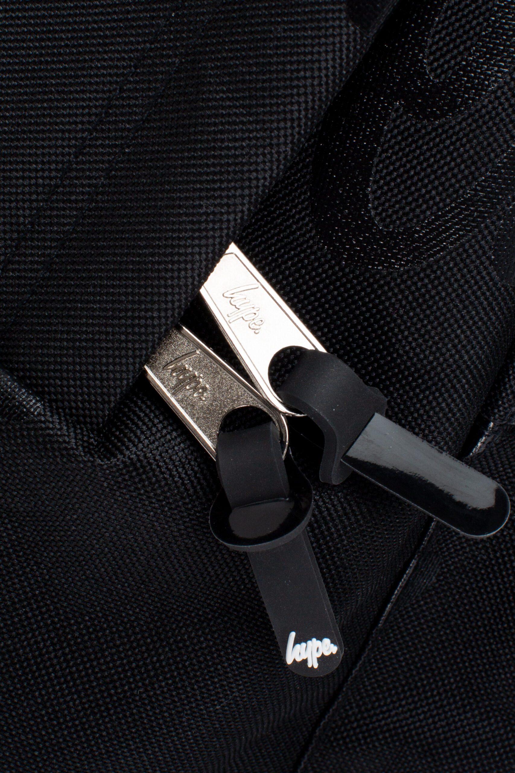 hype black backpack with multiple logos close up zips