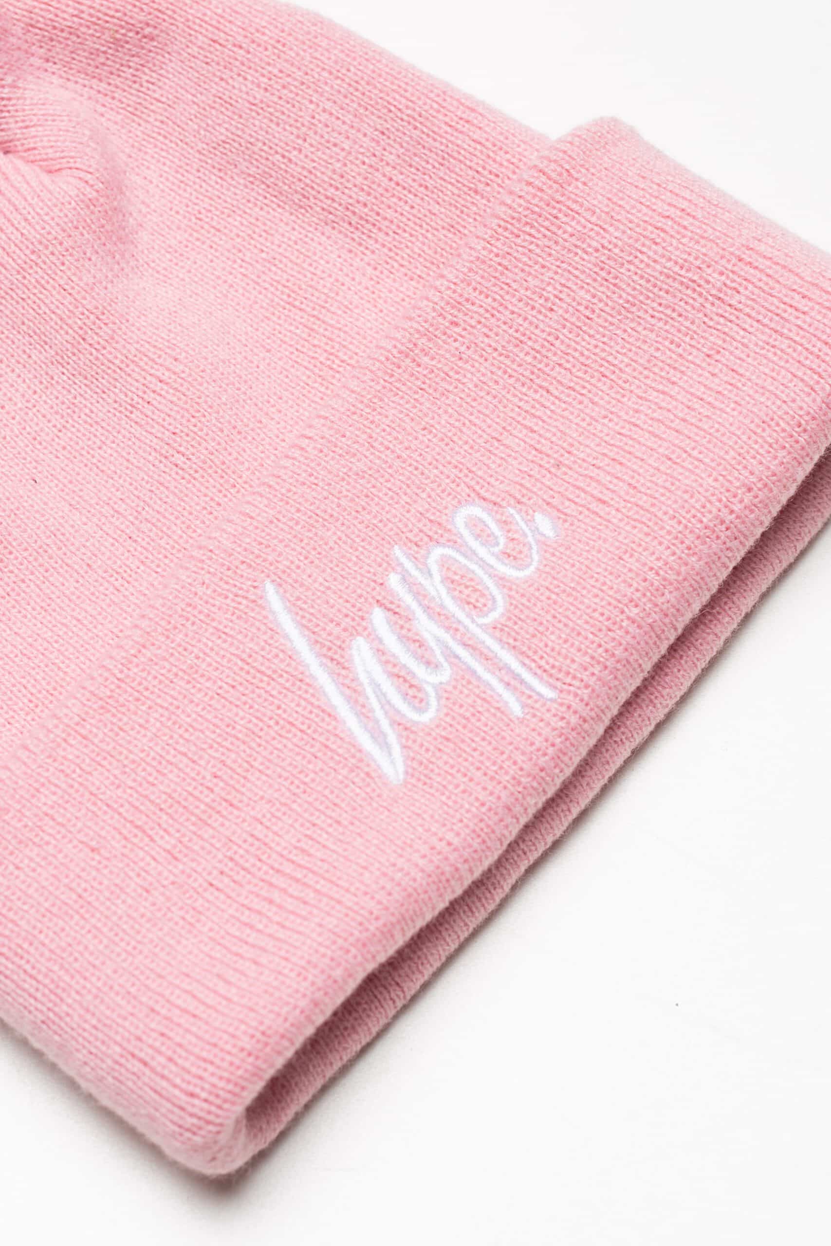 hype pale pink bobble hat close up of logo