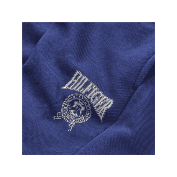 Tommy Hilfiger boys blue shorts with white circular logo logo closeup
