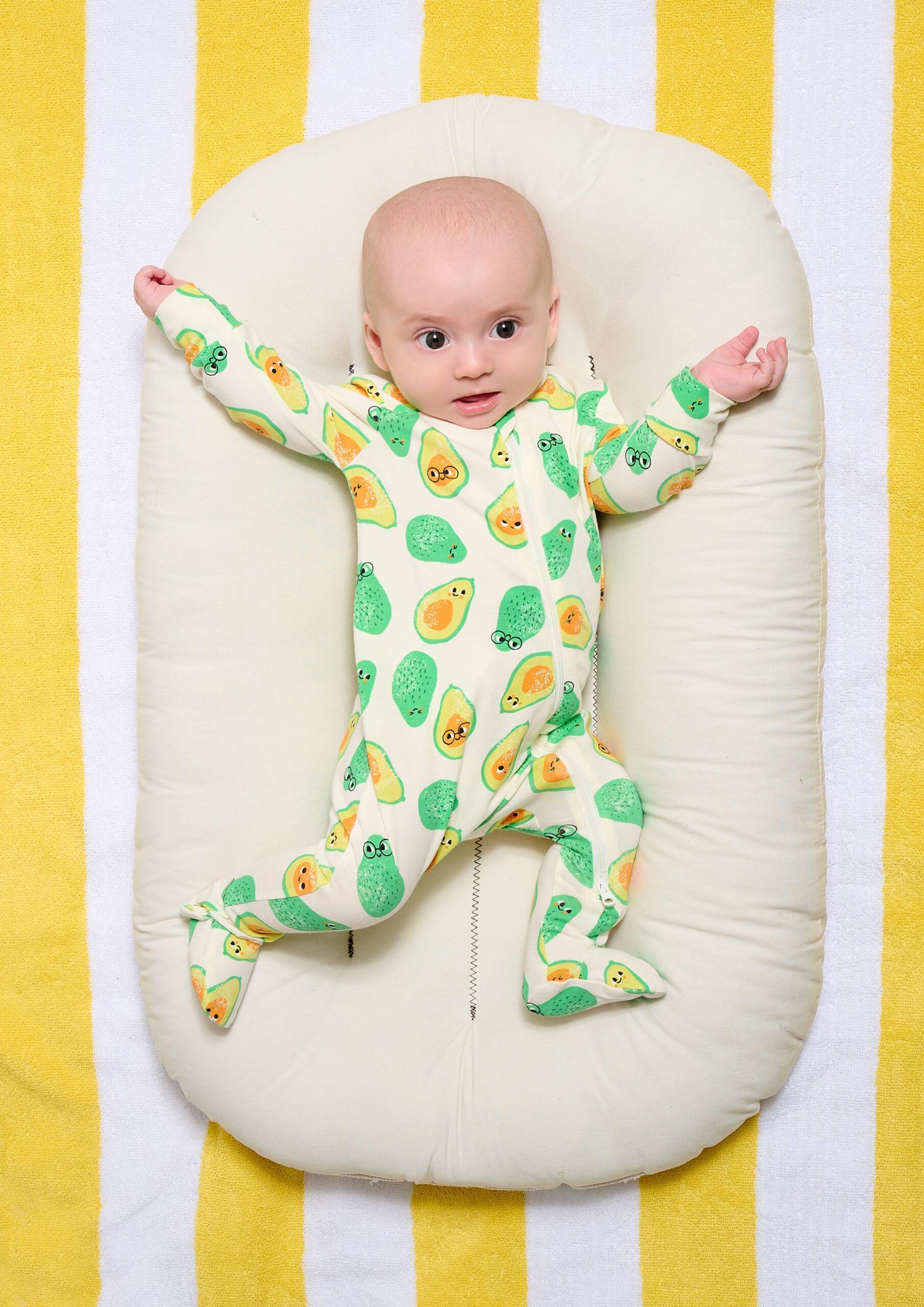 the bonnie mob avocado babygro on model with hands out