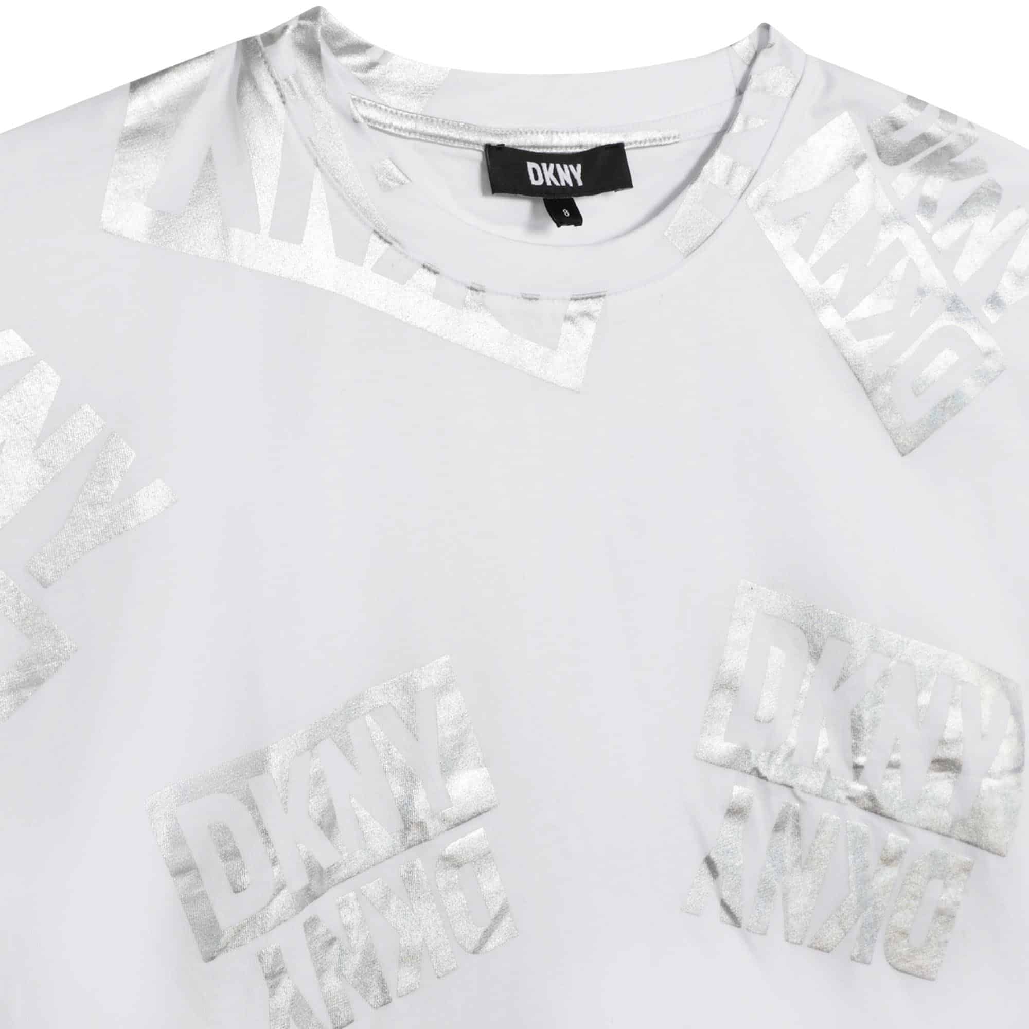 DKNY girls white tshirt with multiple silver logos close up