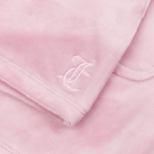 Juicy Couture logo close up on pale pink velour tracksuit