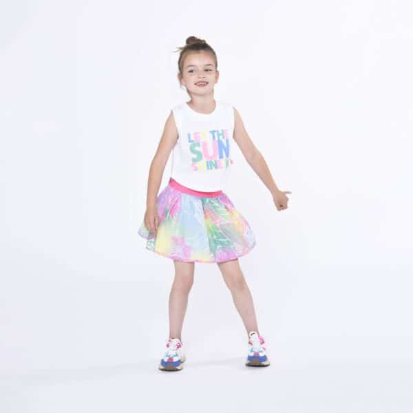 Billieblush model in sun tank top and multi colour skirt