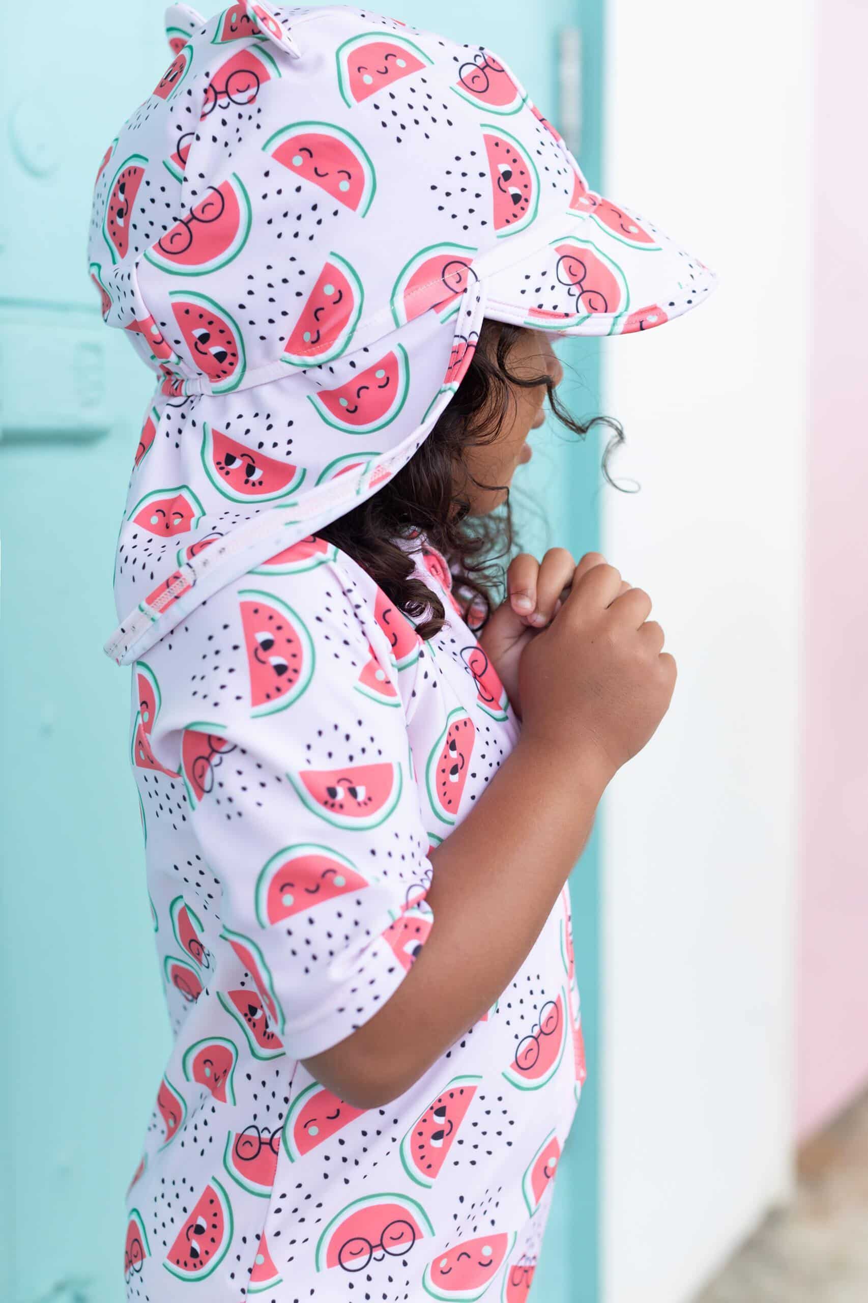 the bonnie mob kids watermelon swim rash suit and hat on model sideview