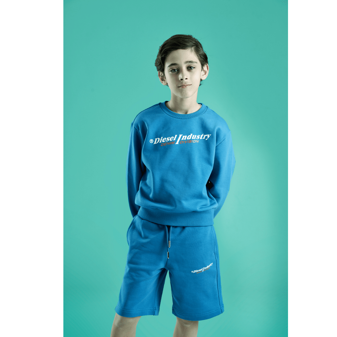 Diesel boys blue sweater and shorts on model