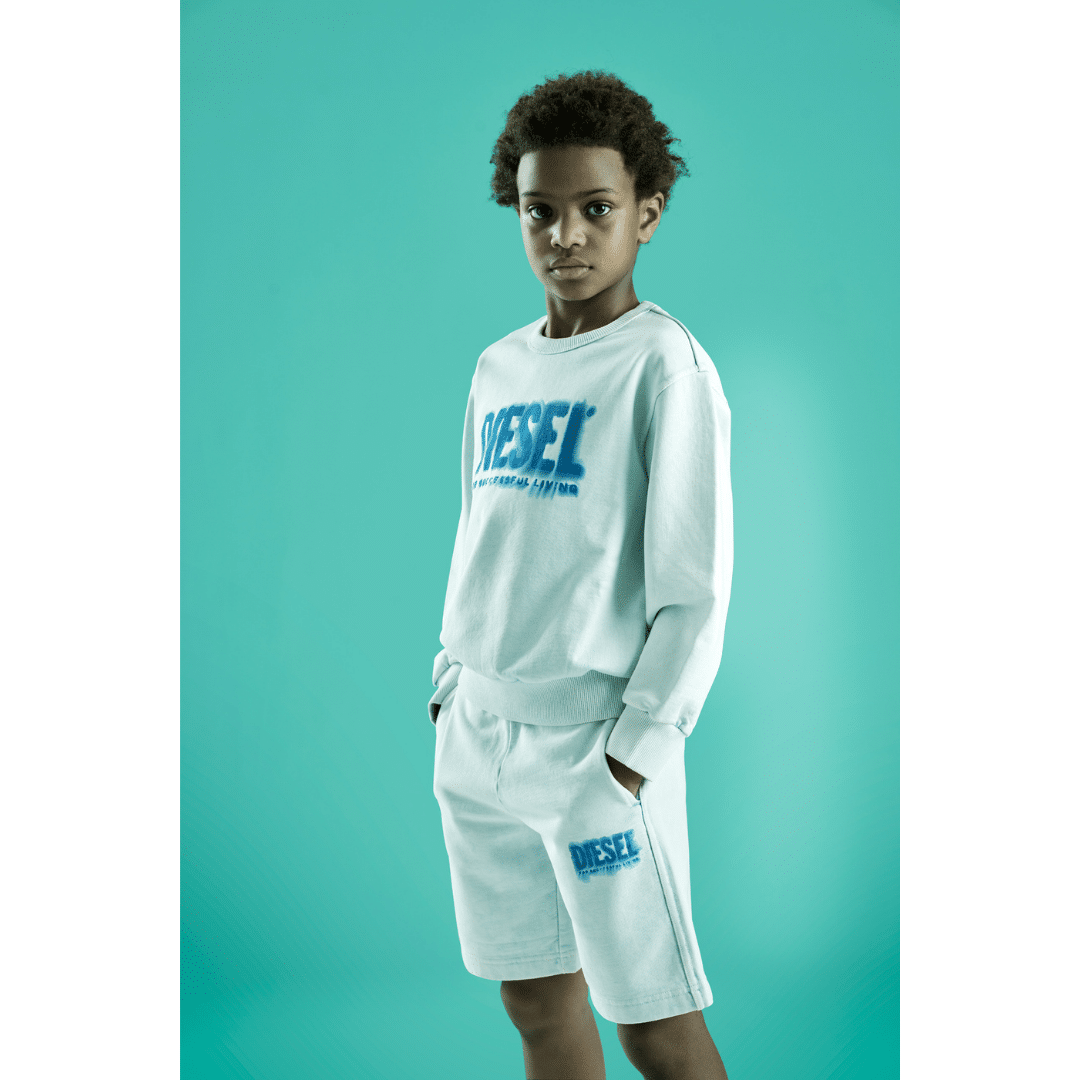Diesel boys white sweater and shorts on model