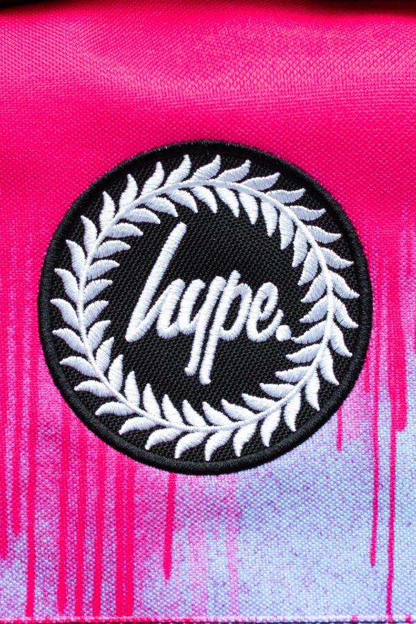 Hype pink and black paint drip backpack logo close up