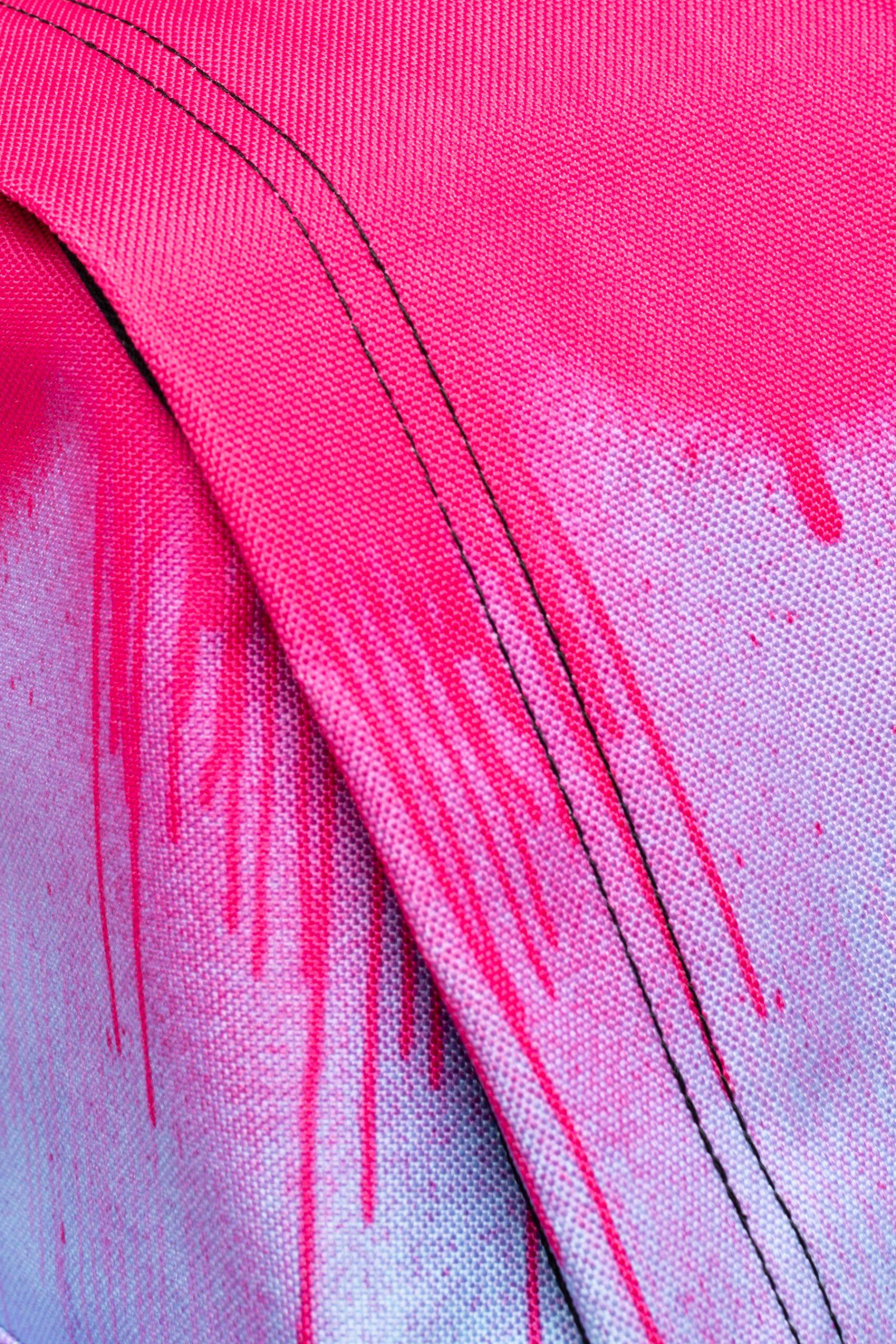 Hype pink and black paint drip backpack seam close up