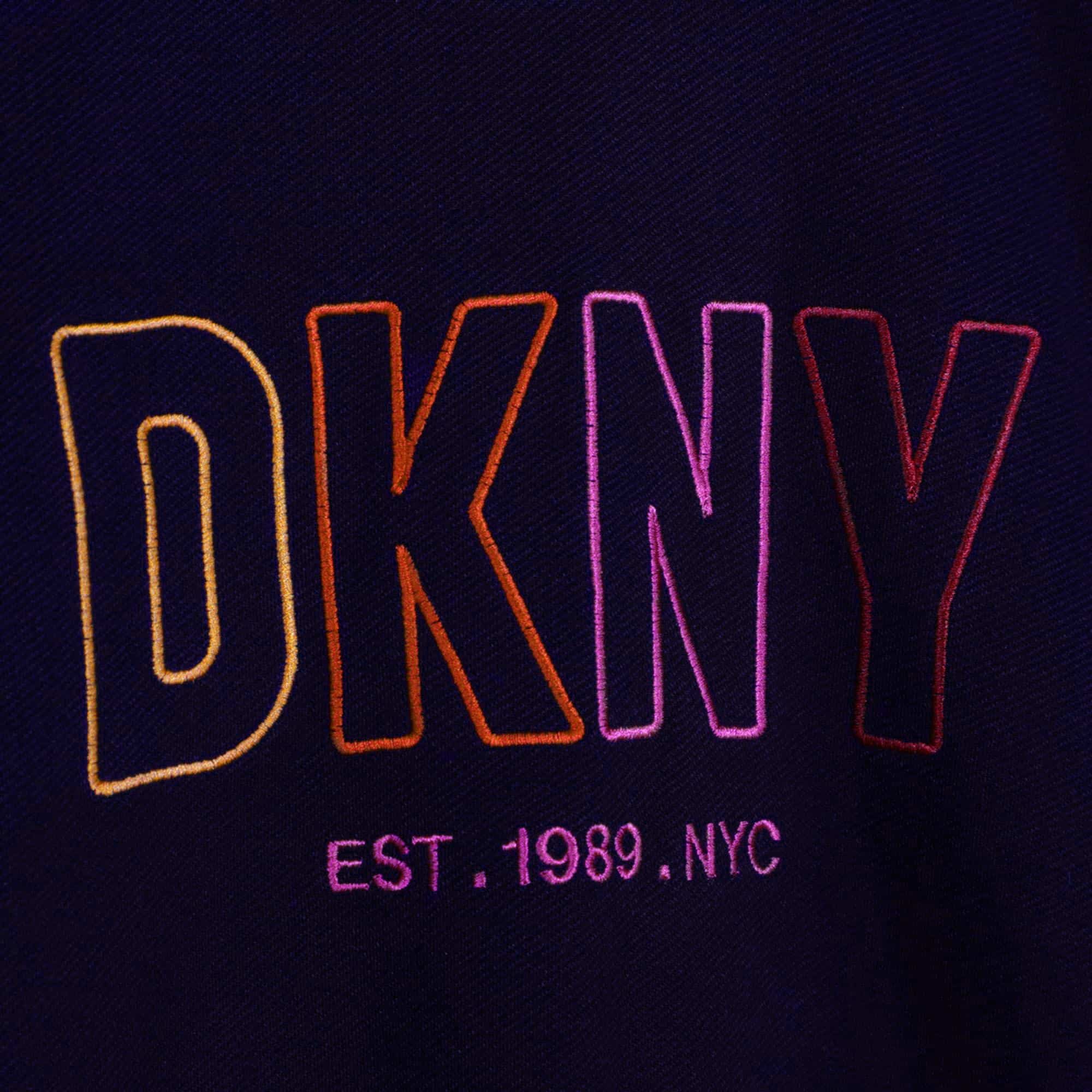 DKNY girls sweater with multi coloured logo close up