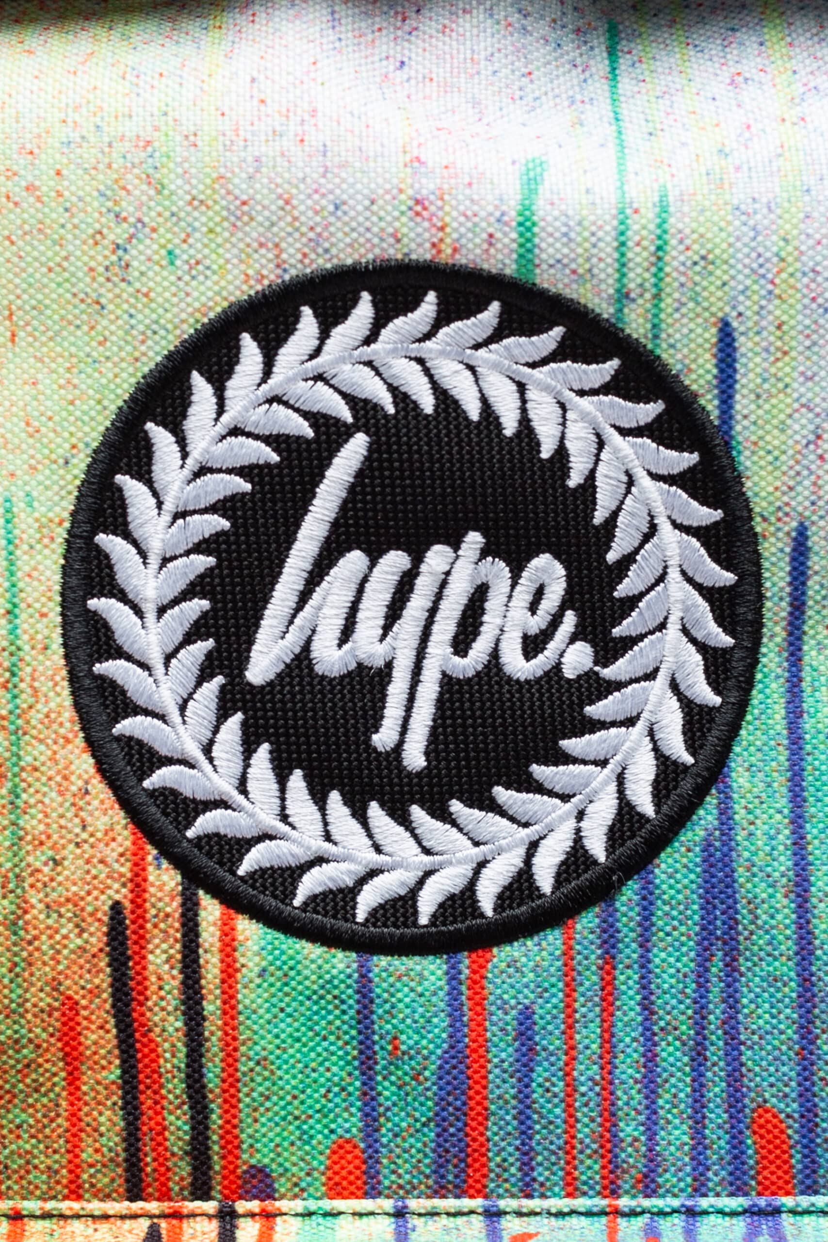 Hype red blue and green paint drip backback logo close up