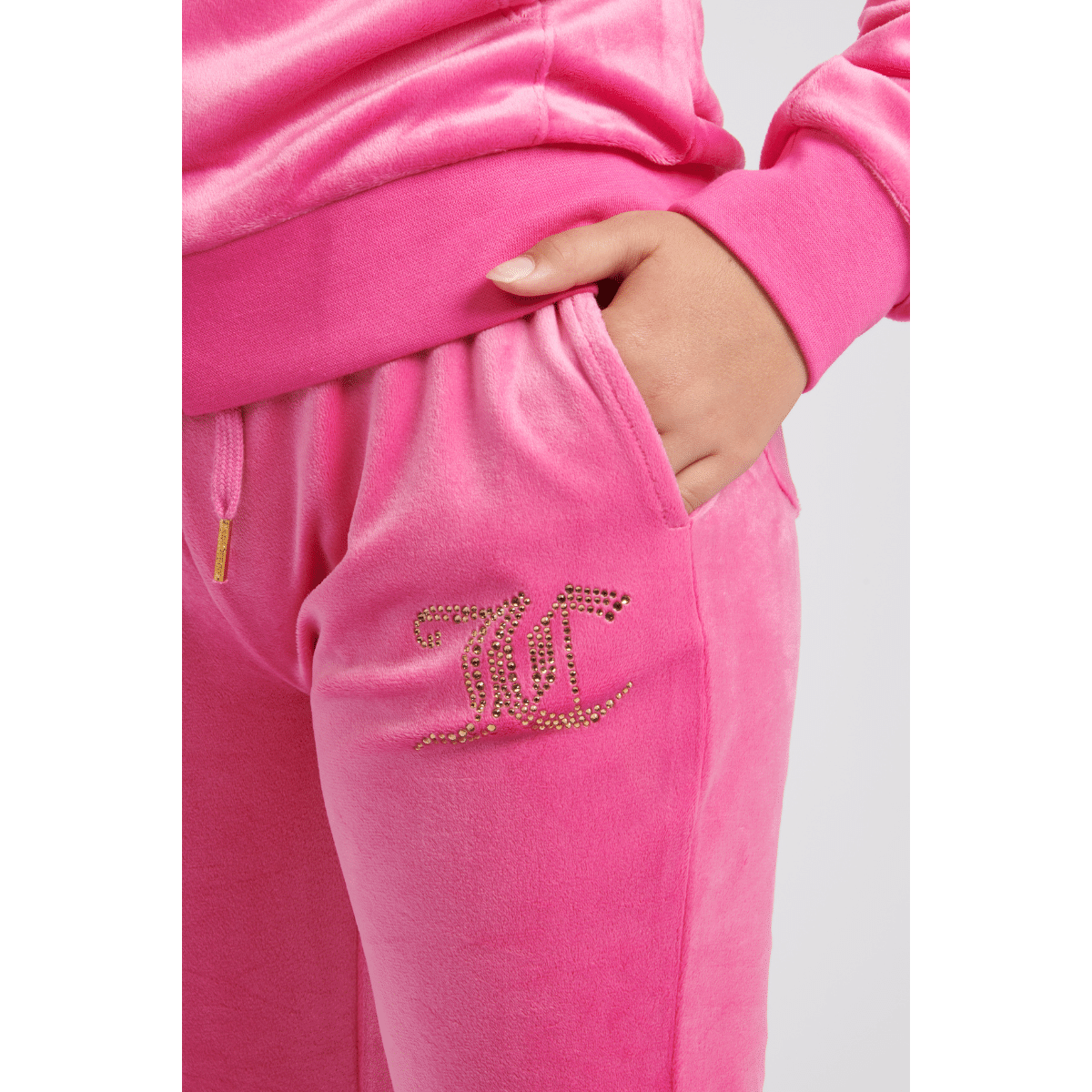 juicy couture girls pink velour bootcut trousers close up on model