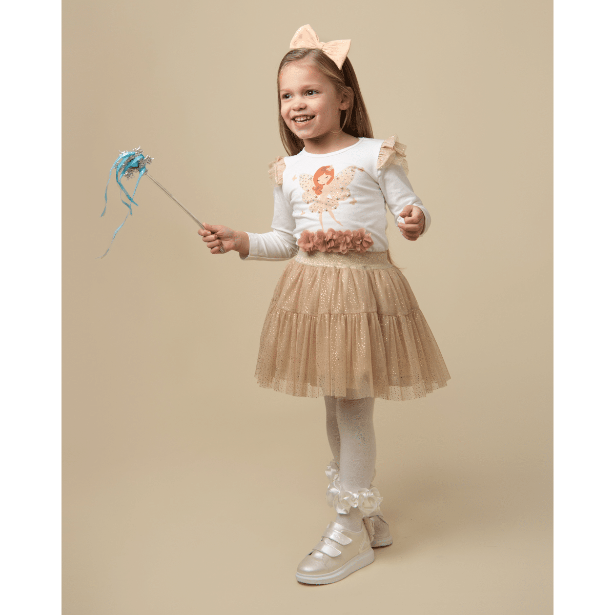 model in caramelo tulle fairy skirt with fairy wand
