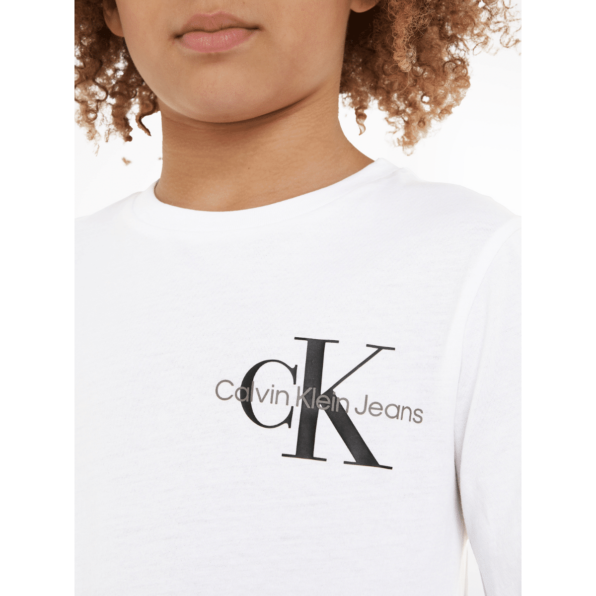 calvin klein childrens white long sleeved top with black logo on model close up