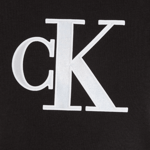 calvin klein large metallic CK logo close up on girls black tshirt