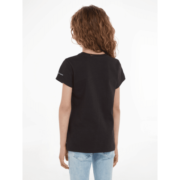calvin klein girls black tshirt with large metallic CK logo back view on model