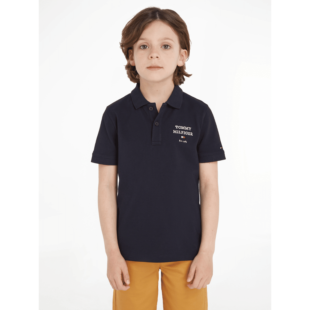 Tommy hilfiger boys black polo shirt logo on model with yellow trousers